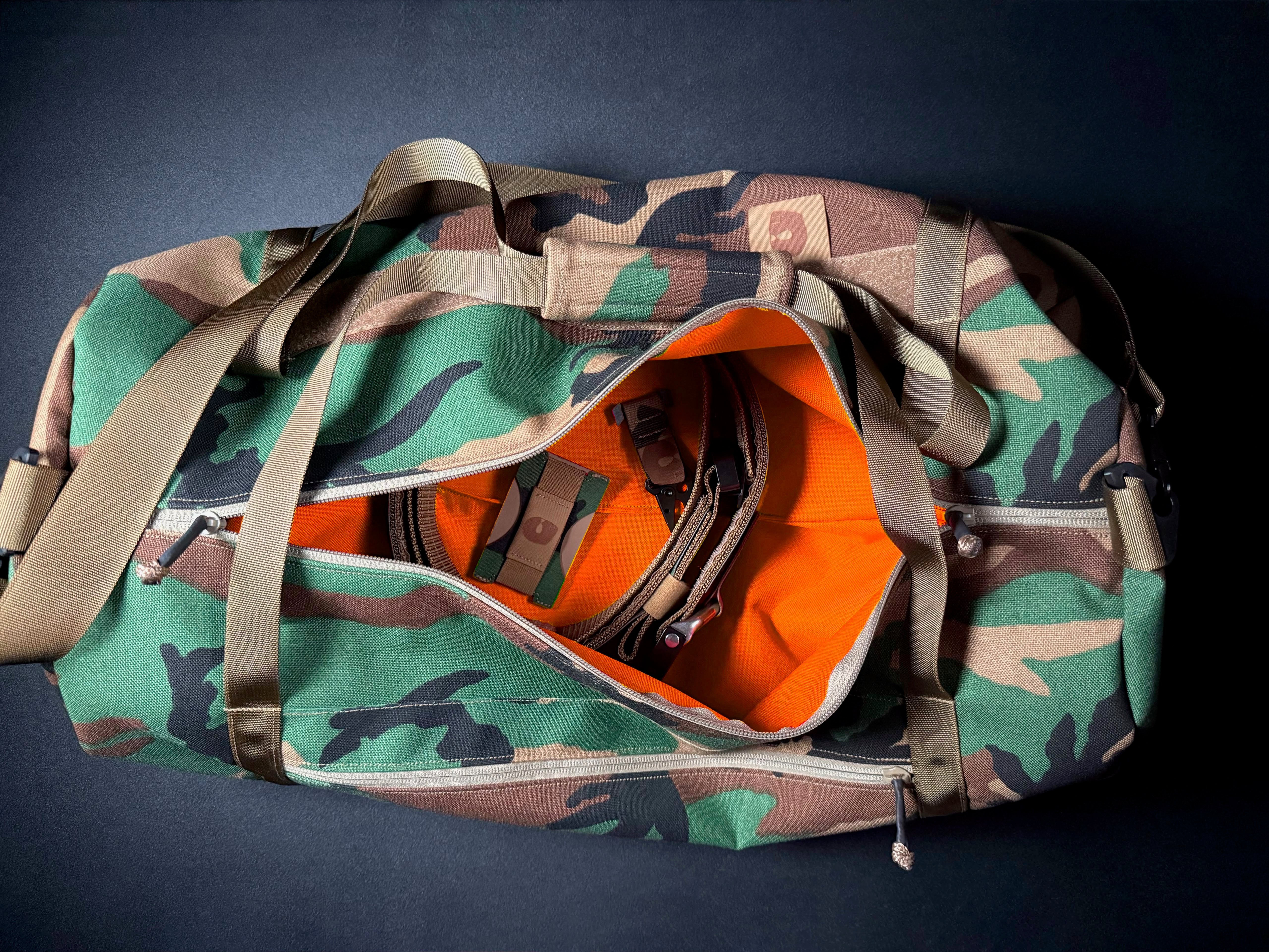 M81 (WOODLAND) DUFFLE W/ HUNTER ORANGE INTERIOR DEADLY CUSTOMS